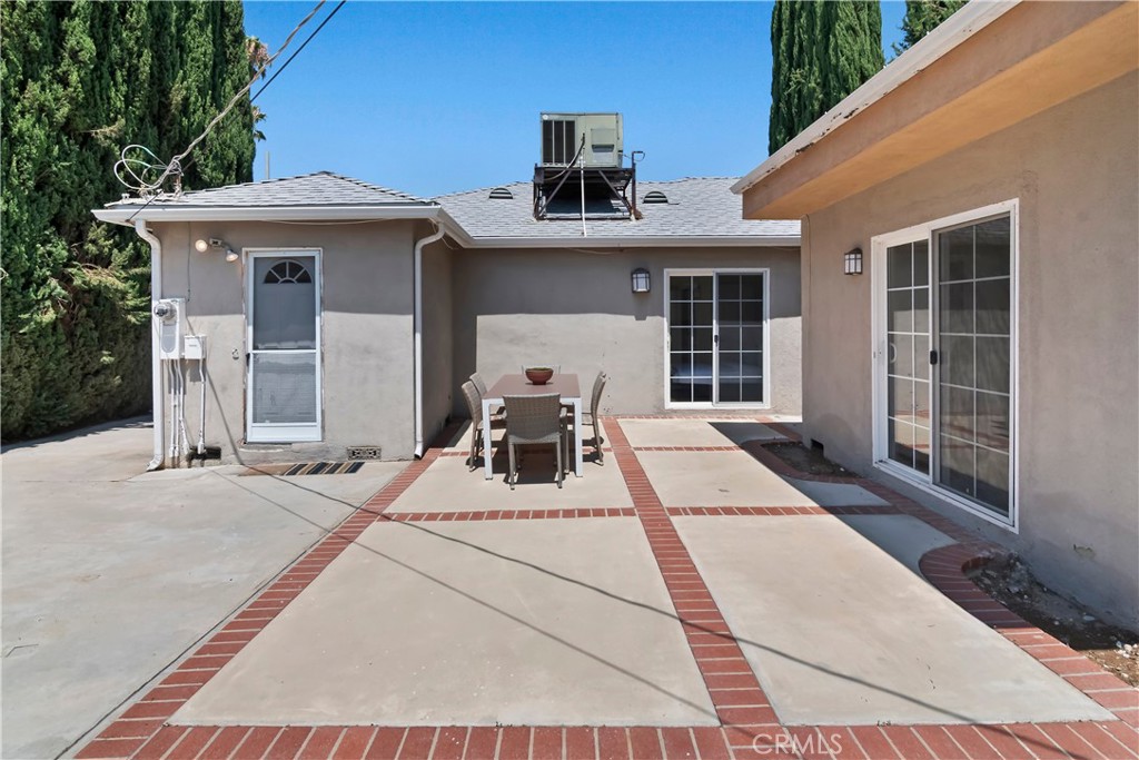16828 Margate Street Encino, CA 91436 - Photo 19 of 21 a view of a patio with a table and chairs and potted plants