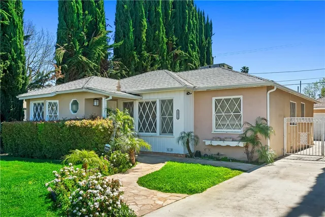 a front view of a house with a garden