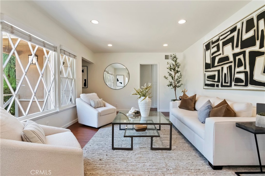 16828 Margate Street Encino, CA 91436 - Photo 3 of 21 a living room with furniture and a large window with garden view