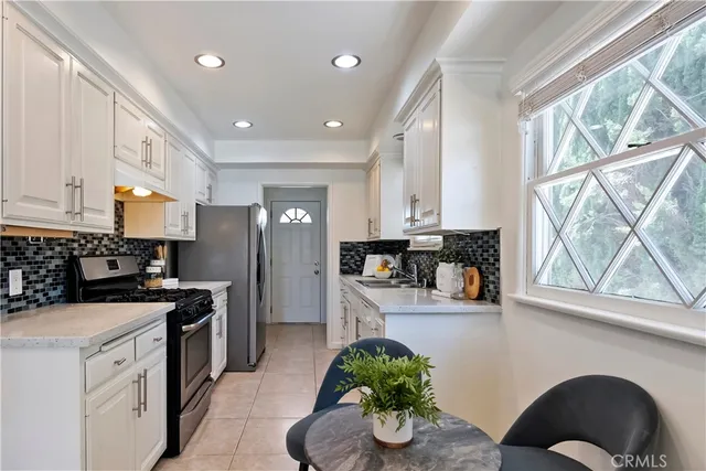 a kitchen with a sink stainless steel appliances and cabinets