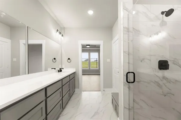 a bathroom with a tub sink and mirror