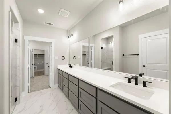 a bathroom with a double vanity sink mirror and double