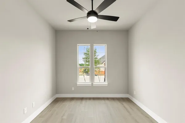 a view of room with window and ceiling fan