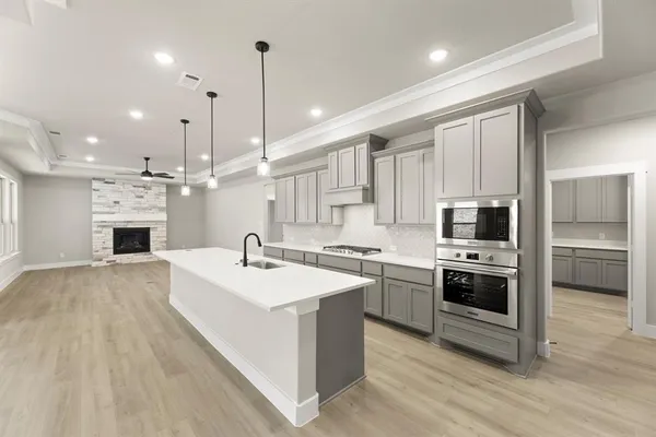 a large kitchen with stainless steel appliances kitchen island a large island a oven a stove and a center island