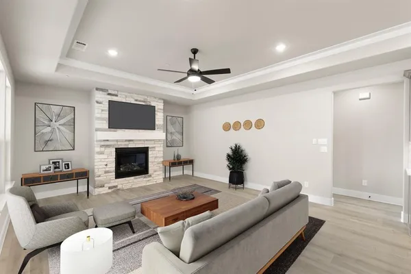 a living room with furniture a fireplace and a flat screen tv