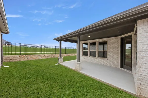 a view of an house with backyard space and balcony