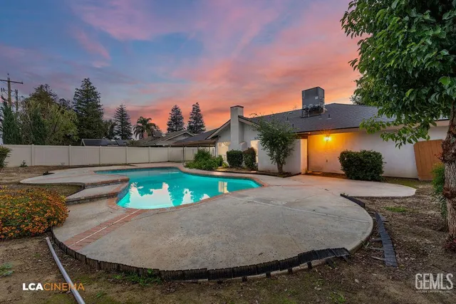 swimming pool view with a seating space