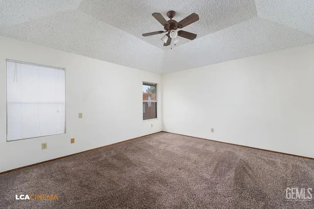 an empty room with a empty space and a ceiling fan