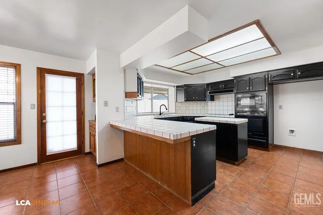 a kitchen with a stove and a refrigerator
