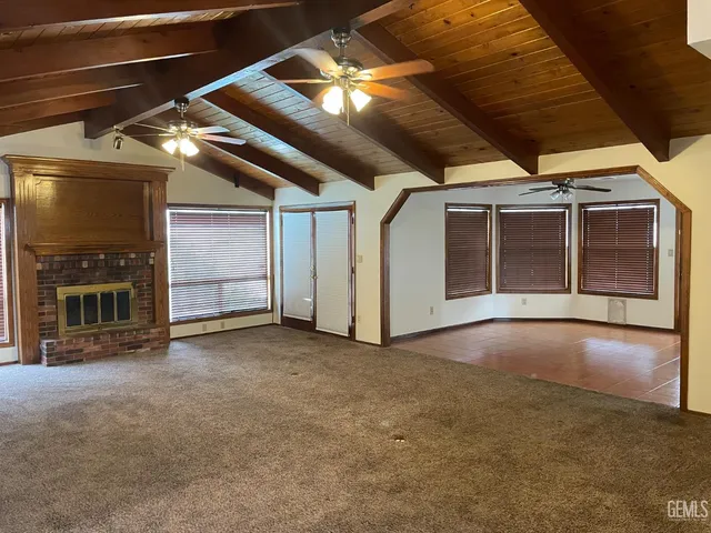 a view of an empty room with a fireplace