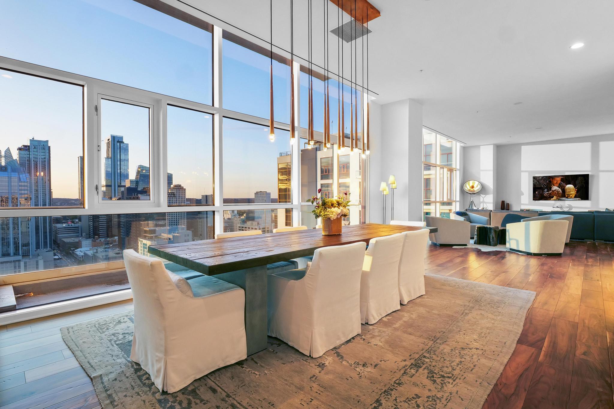 555 East 5th Street, Unit 3022 Austin, TX 78701 - Photo 4 of 40 Dining area with wood-type flooring, a view of skyline, and floor to ceiling windows