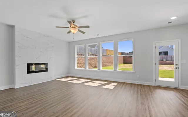 an empty room with a window and a fan