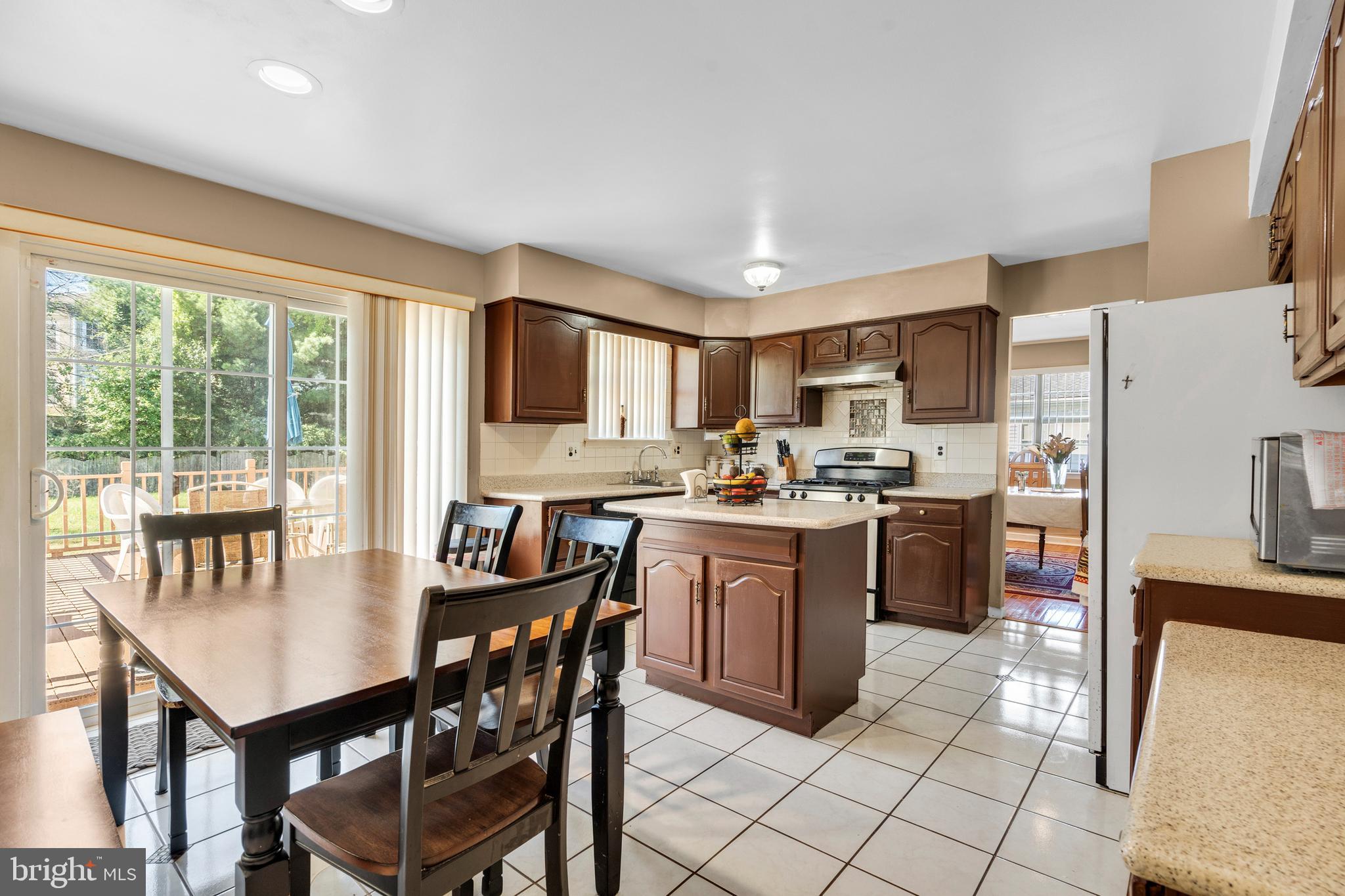2 West High Ridge Road Cherry Hill, NJ 08003 - Photo 12 of 42 a kitchen with stainless steel appliances granite countertop a stove a refrigerator a kitchen island and chairs