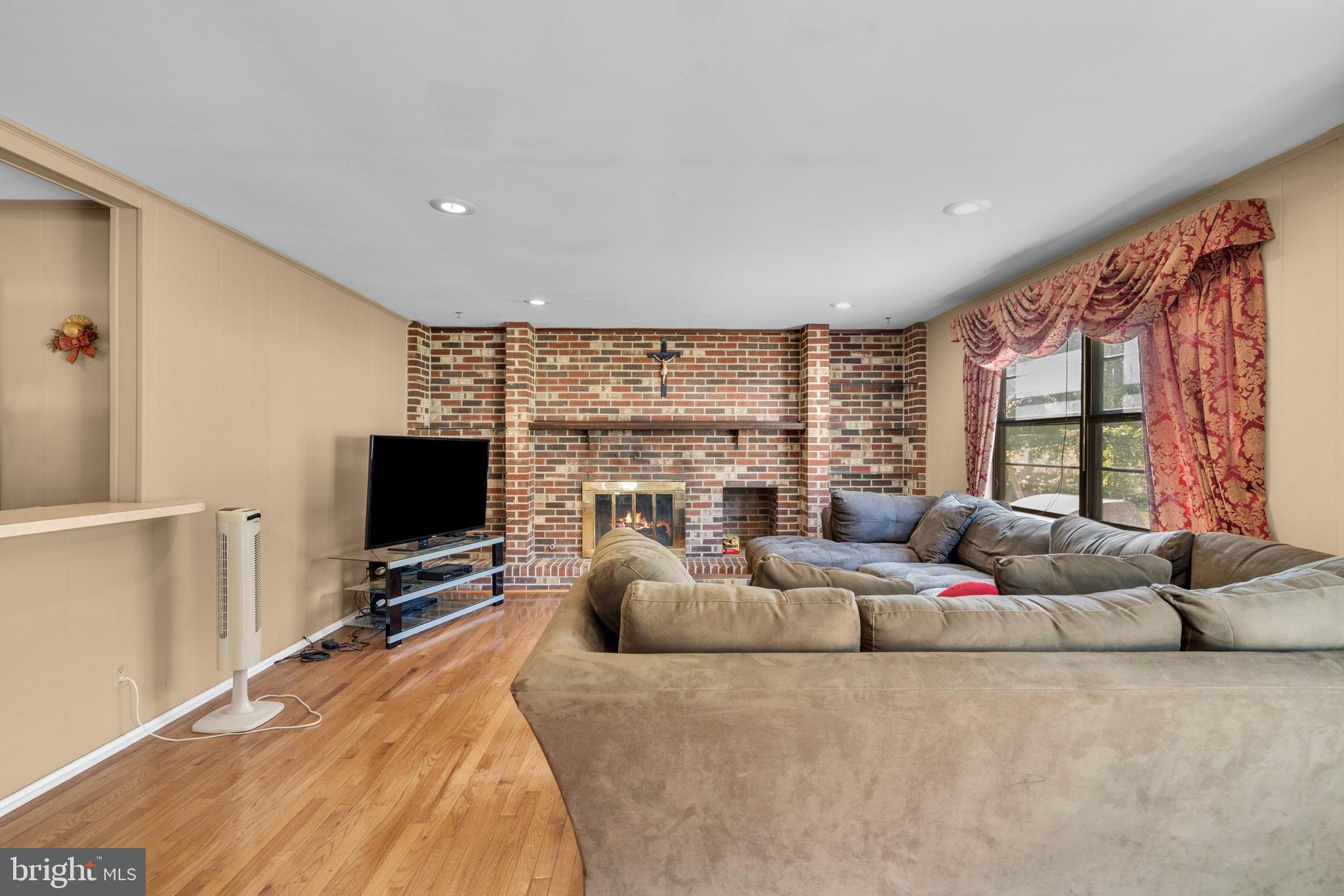 2 West High Ridge Road Cherry Hill, NJ 08003 - Photo 15 of 42 a living room with furniture a flat screen tv and a large window