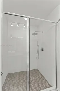 a view of kitchen with furniture and refrigerator