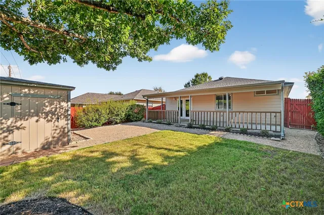 a view of a house with a yard and a garden