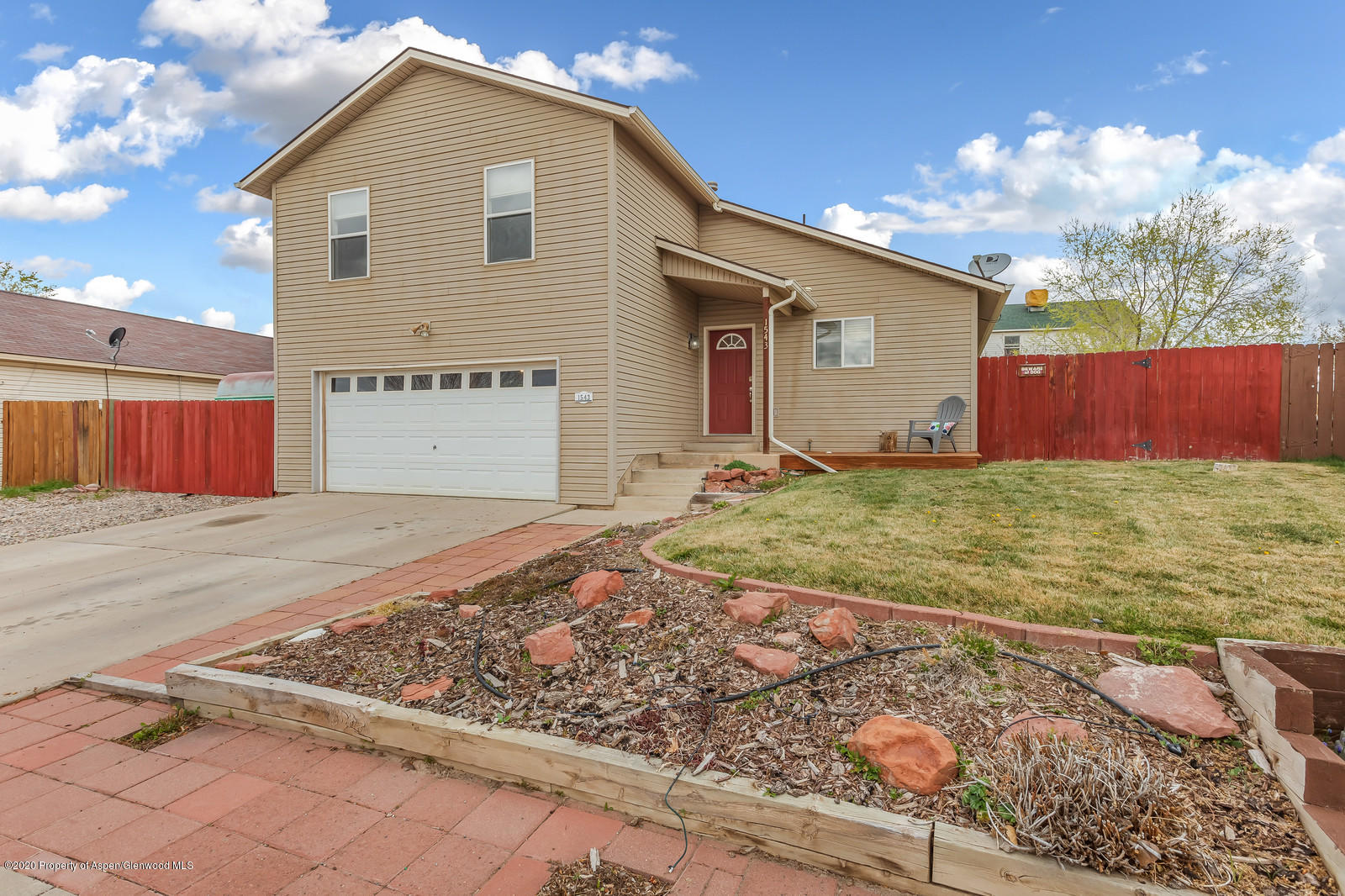 1543 Beech Street Rifle, CO 81650 - Photo 1 of 20 a front view of a house with a yard