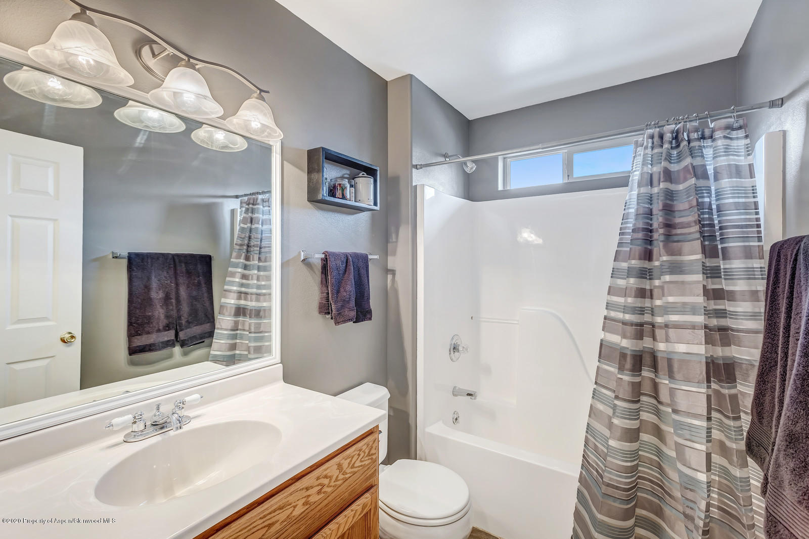 1543 Beech Street Rifle, CO 81650 - Photo 12 of 20 a bathroom with a sink toilet and shower