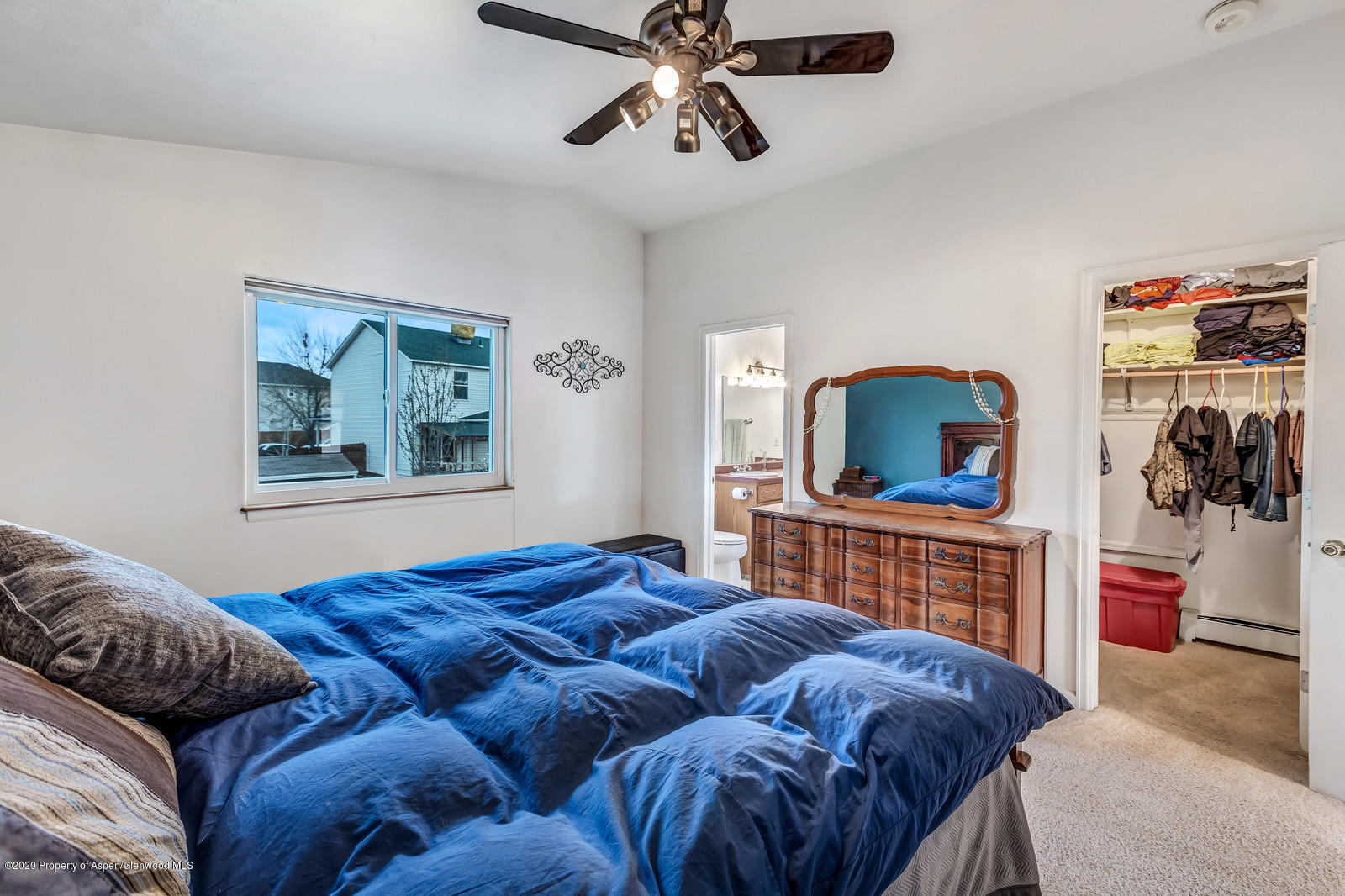 1543 Beech Street Rifle, CO 81650 - Photo 13 of 20 a bedroom with a bed and dresser