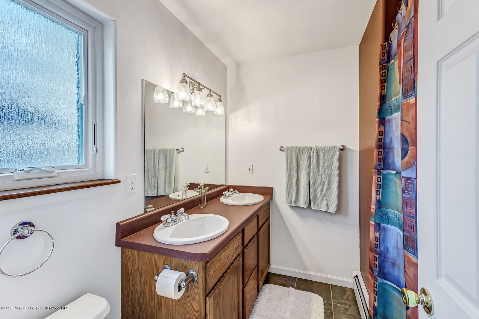 1543 Beech Street Rifle, CO 81650 - Photo 14 of 20 a bathroom with a sink a toilet and a mirror