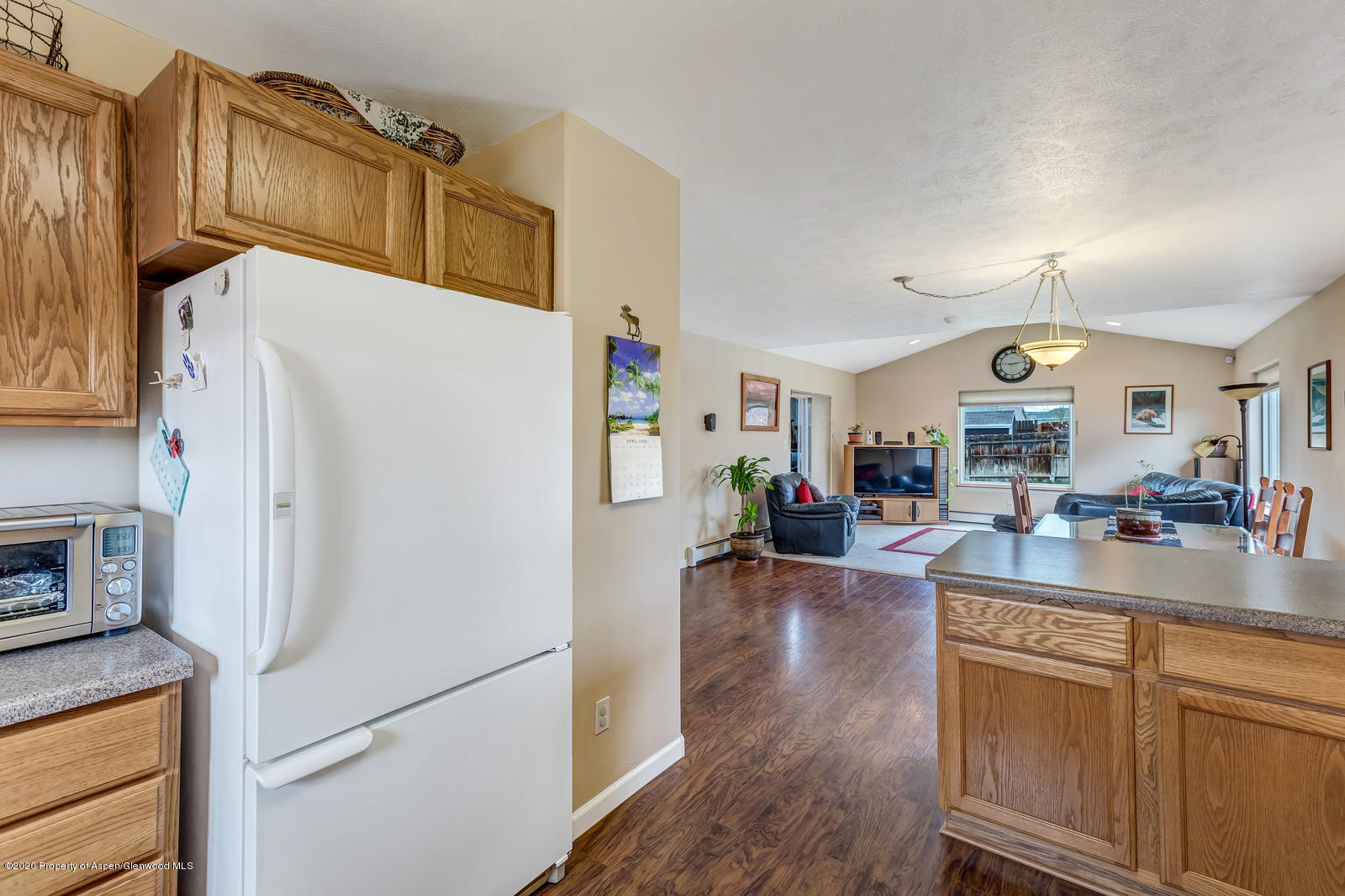1543 Beech Street Rifle, CO 81650 - Photo 9 of 20 a kitchen with a refrigerator a stove and cabinets
