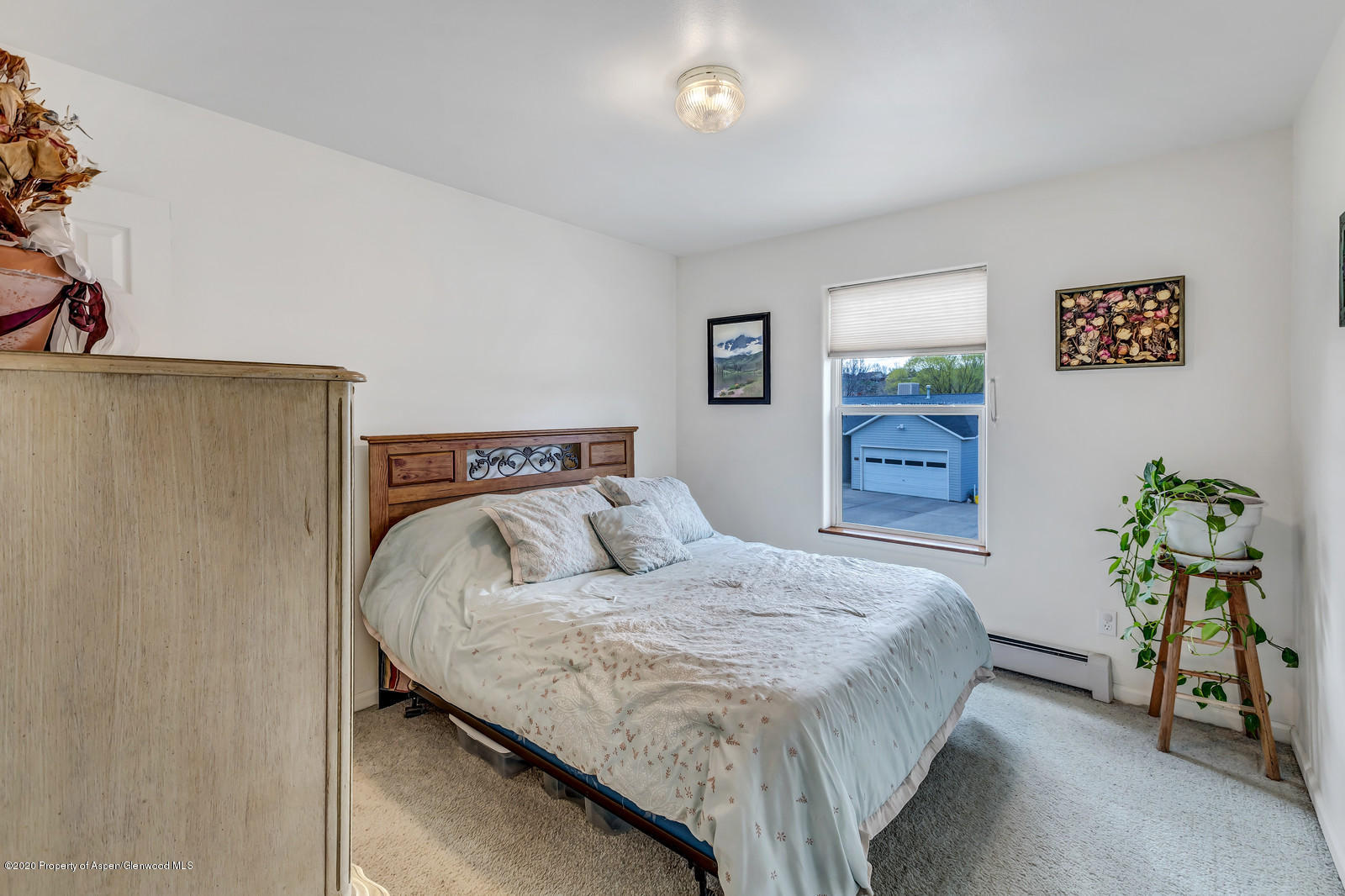 1543 Beech Street Rifle, CO 81650 - Photo 10 of 20 a bedroom with a bed and painting on the wall