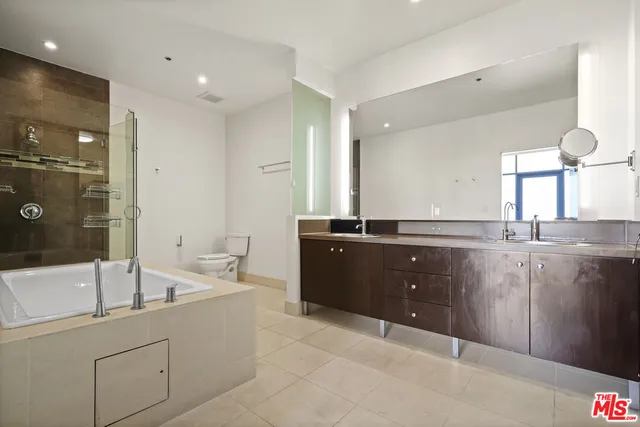 a bathroom with a bathtub sink and mirror