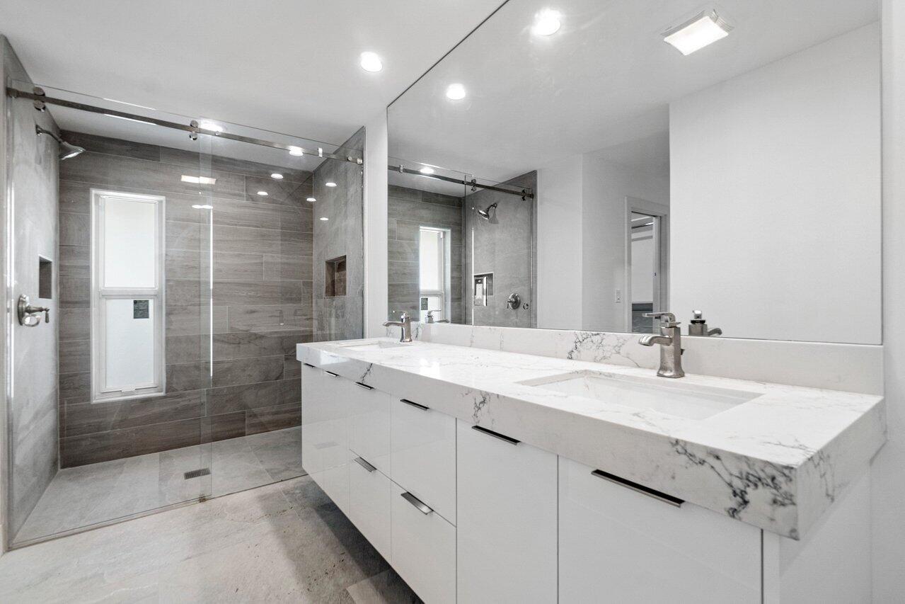914 Foxpointe Circle Delray Beach, FL 33445 - Photo 14 of 19 a bathroom with a granite countertop sink mirror and shower