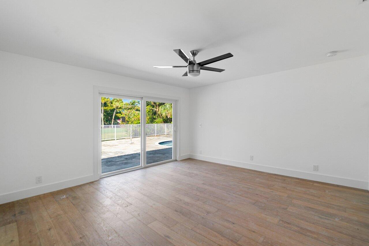 914 Foxpointe Circle Delray Beach, FL 33445 - Photo 6 of 19 wooden floor in an empty room with a window