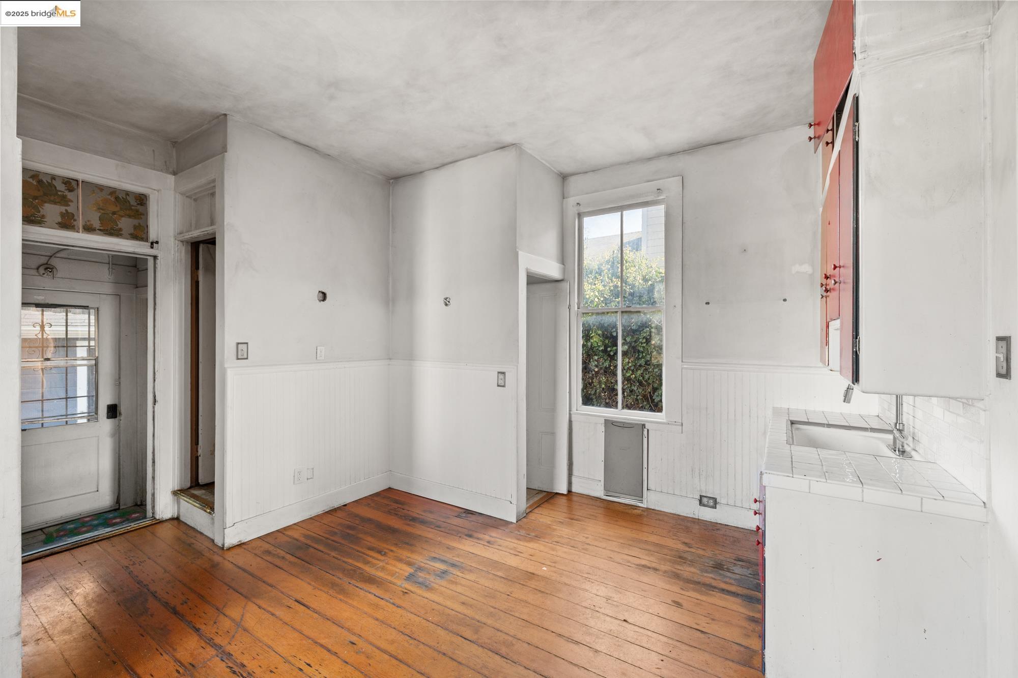 1746 8th Street Oakland, CA 94607 - Photo 13 of 52 wooden floor in an empty room with a window