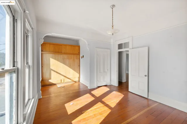 a view of a room with wooden floor and windows