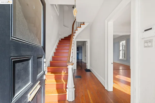 a view of entryway and hall with wooden floor