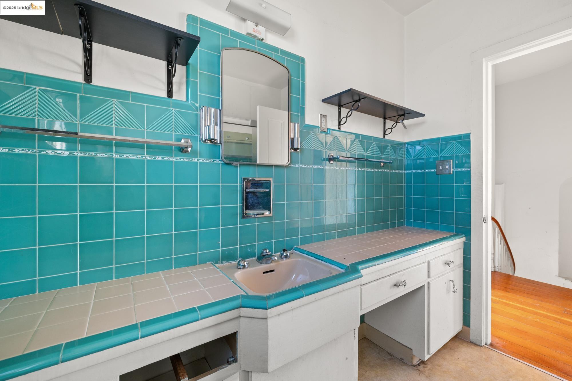 1746 8th Street Oakland, CA 94607 - Photo 22 of 52 a bathroom with a sink and a mirror