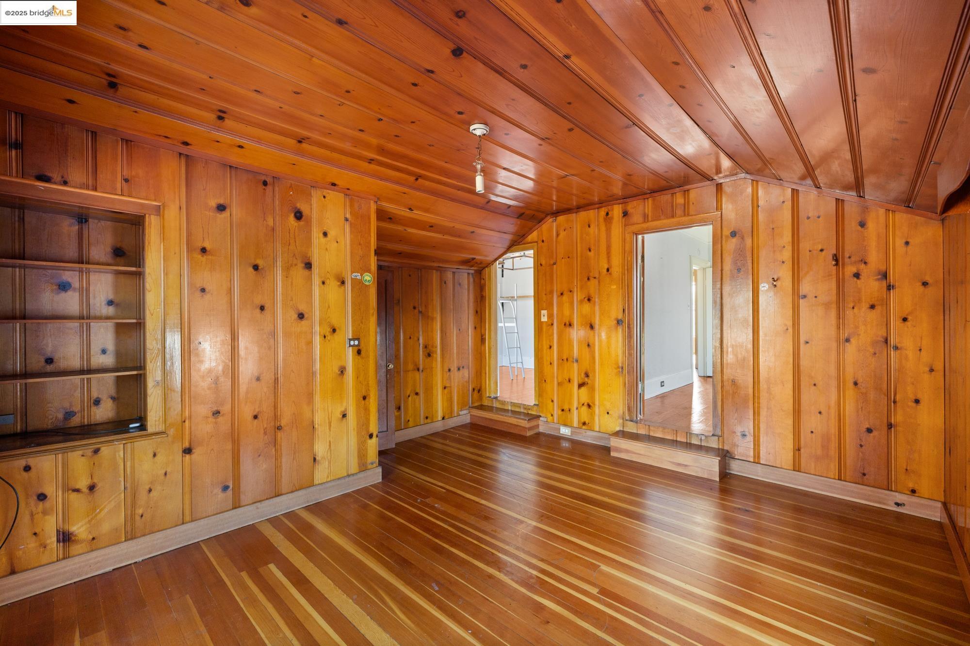 1746 8th Street Oakland, CA 94607 - Photo 27 of 52 a view of an empty room with wooden floor and a window