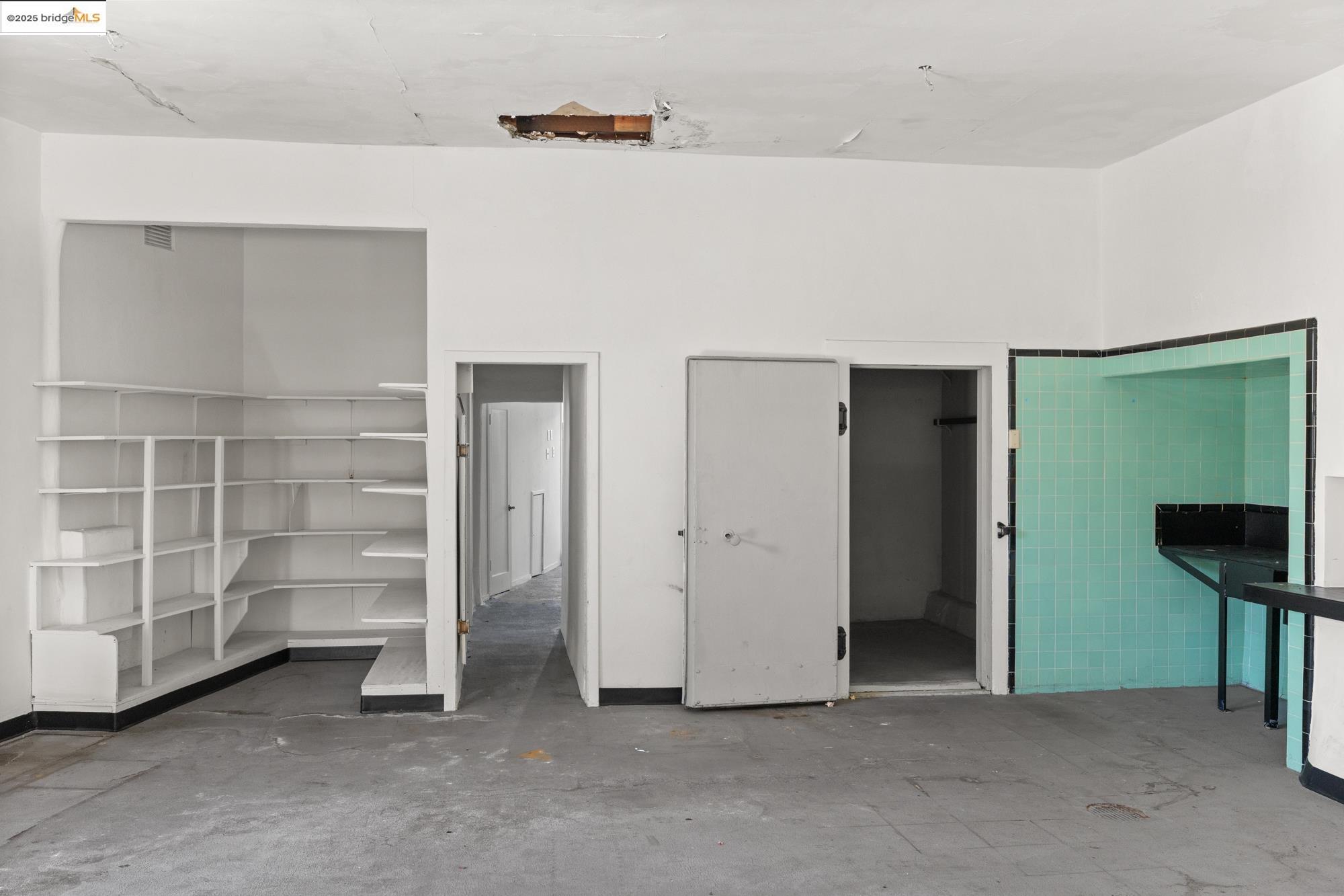 1746 8th Street Oakland, CA 94607 - Photo 34 of 52 a view of an empty room with cabinet and a window