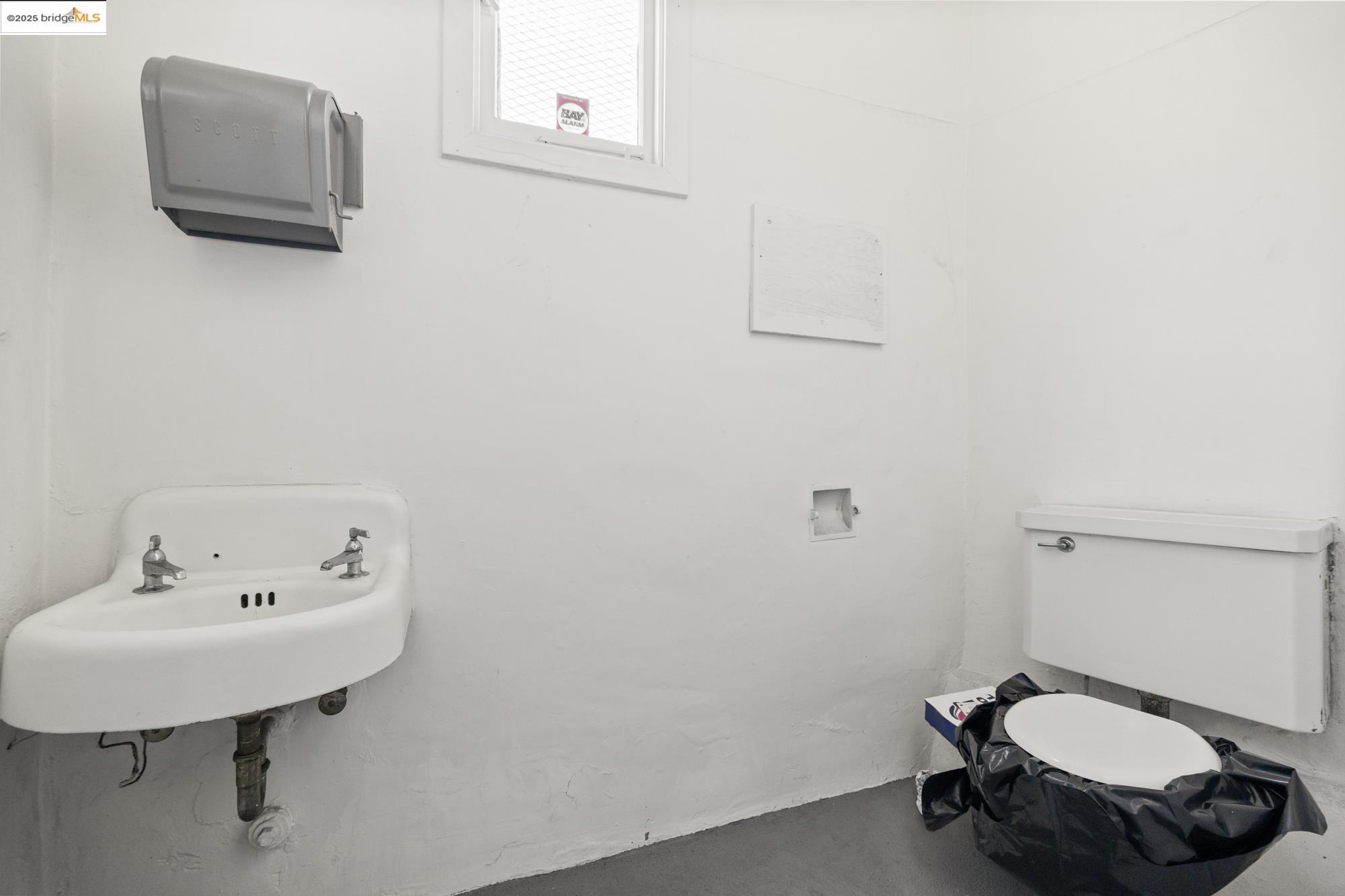 1746 8th Street Oakland, CA 94607 - Photo 37 of 52 a bathroom with a sink a toilet and mirror