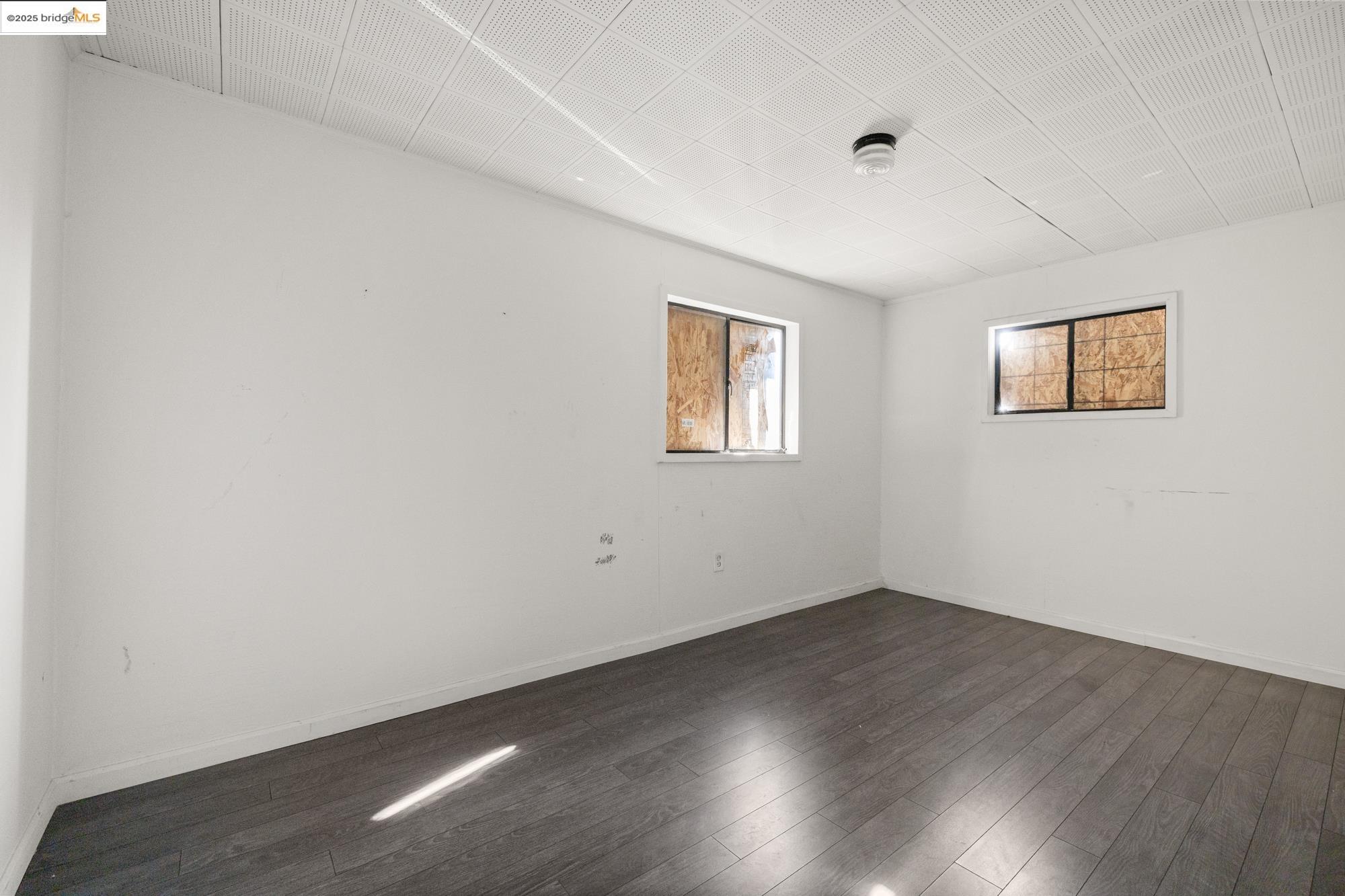 1746 8th Street Oakland, CA 94607 - Photo 42 of 52 a view of empty room with wooden floor and fan