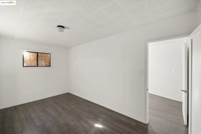 a view of a room with wooden floor and white walls