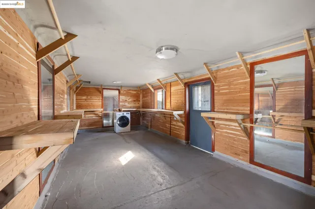 a view of a livingroom with furniture and a kitchen