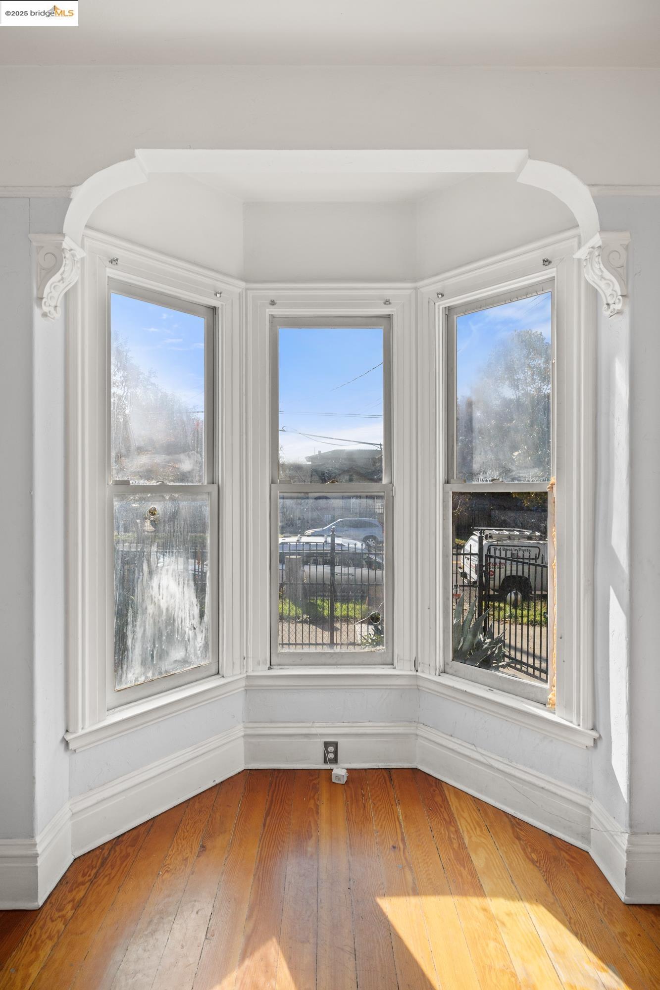 1746 8th Street Oakland, CA 94607 - Photo 5 of 52 a view of an empty room with a large window and wooden floor