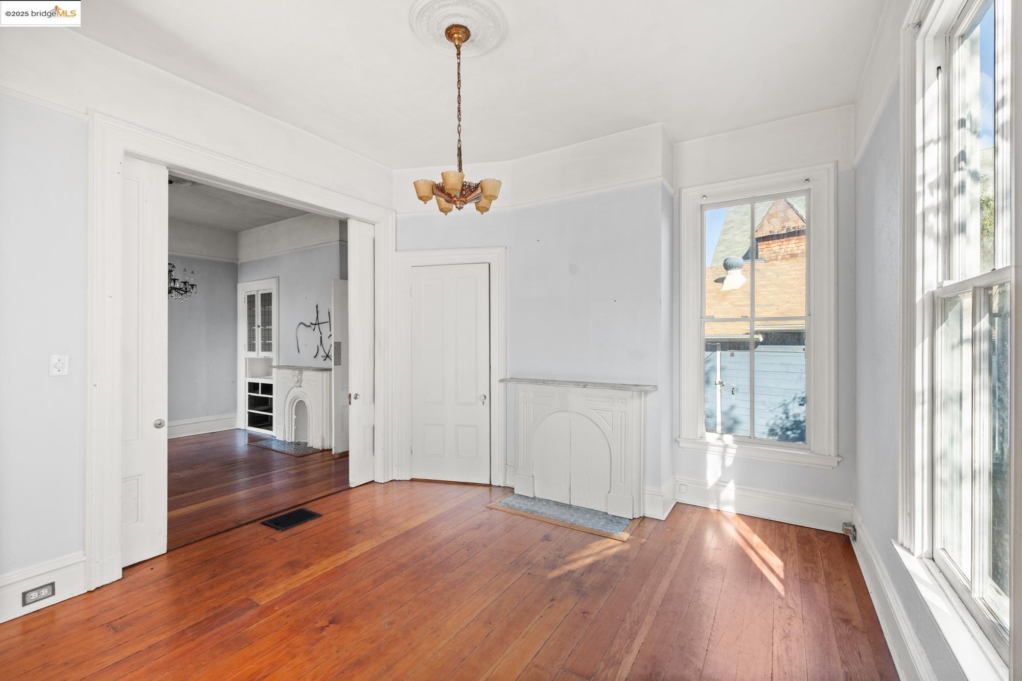 1746 8th Street Oakland, CA 94607 - Photo 8 of 52 a view of empty room with wooden floor and windows