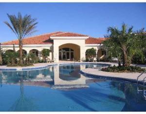 37 Harbour Isle Drive East, Unit 101 Fort Pierce, FL 34949 - Photo 2 of 12 a view of swimming pool with outdoor seating and house in the background
