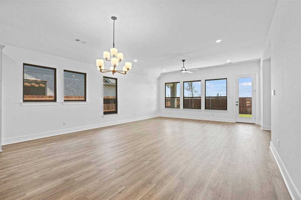 1792 Monarch Way Oak Point, TX 75068 - Photo 11 of 26 a view of an empty room with wooden floor and a window