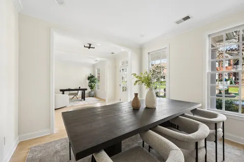 a dining room with furniture and wooden floor