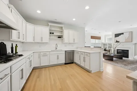 a kitchen with granite countertop white cabinets and white appliances