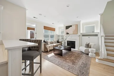 a living room with furniture a fireplace and a window