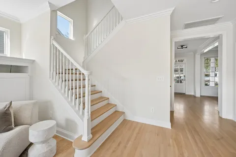 a view of entryway and hall with wooden floor