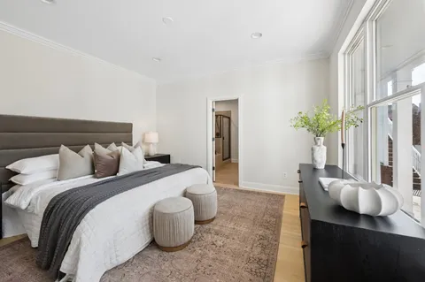 a bedroom with a bed and a potted plant