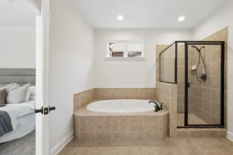 a bathroom with a tub and shower
