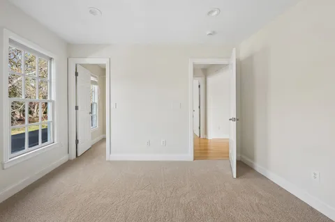 an empty room with windows and closet